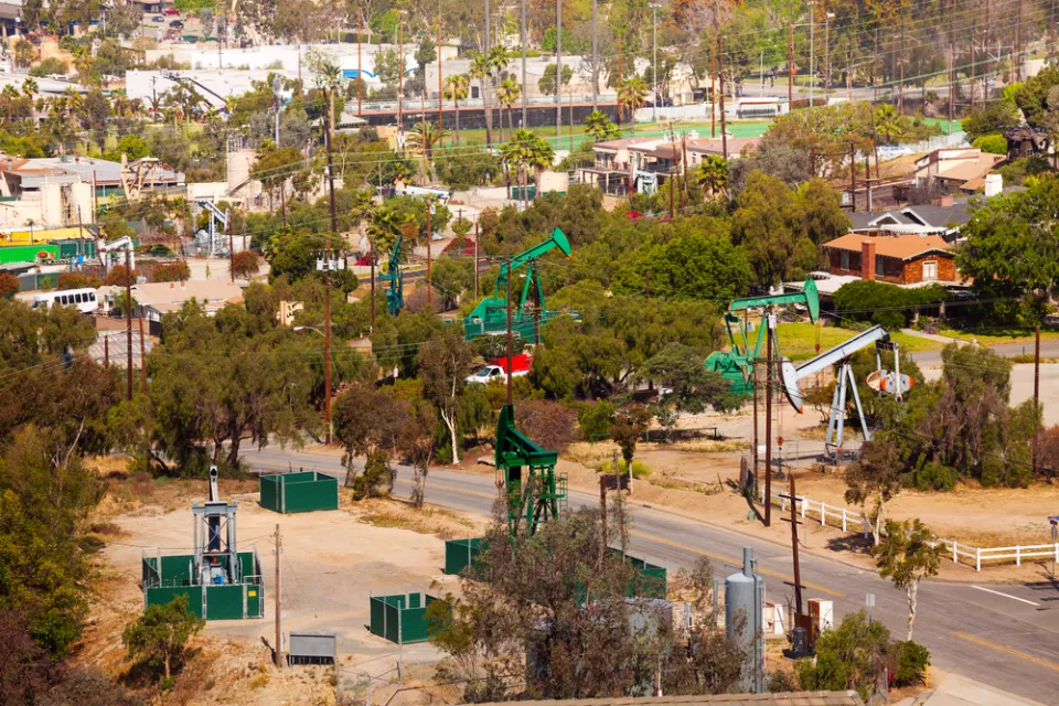 View of neighborhood with oil wells between houses